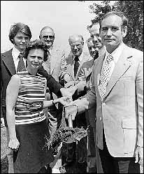 A group of individuals holding a shovel of dirt at the groundbreaking ceremony of the UNI-Dome.