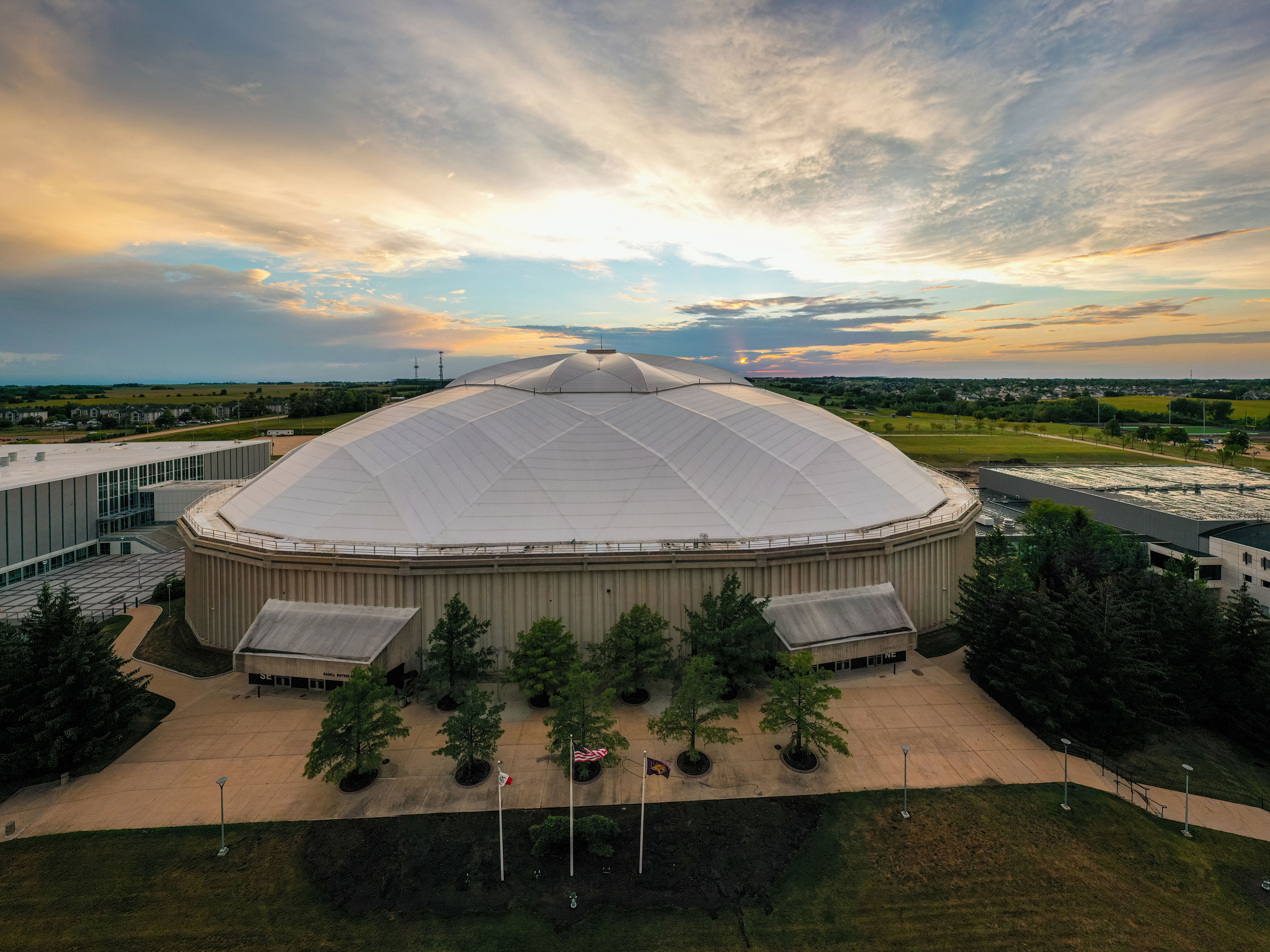 The outside of the UNI-Dome at sunset.